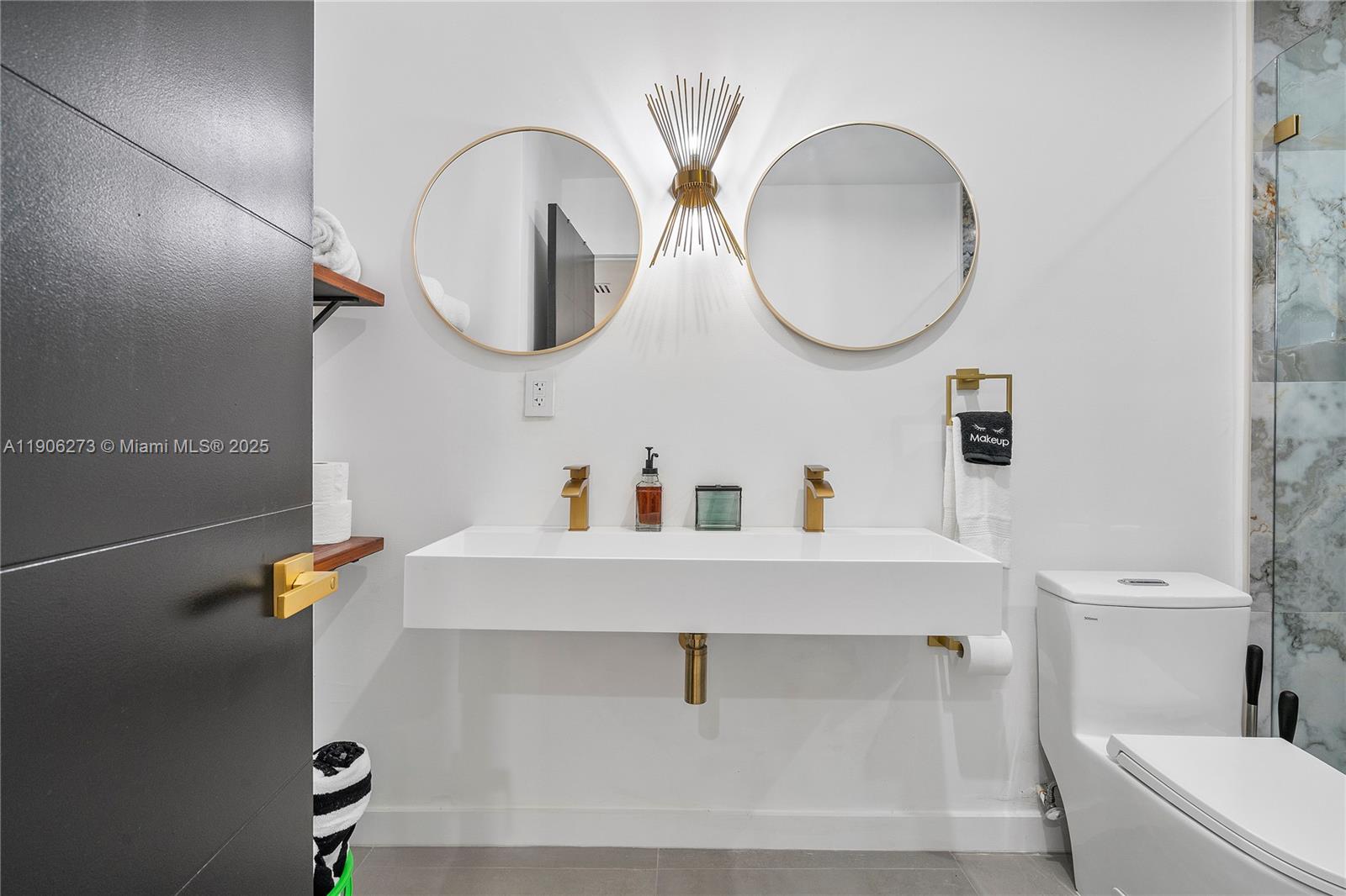 256 Northwest 57th Street Miami, FL 33127 - Photo 7 of 45 a bathroom with a sink and a mirror