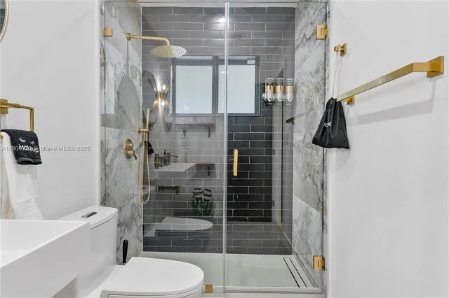 a bathroom with a sink a toilet and a mirror