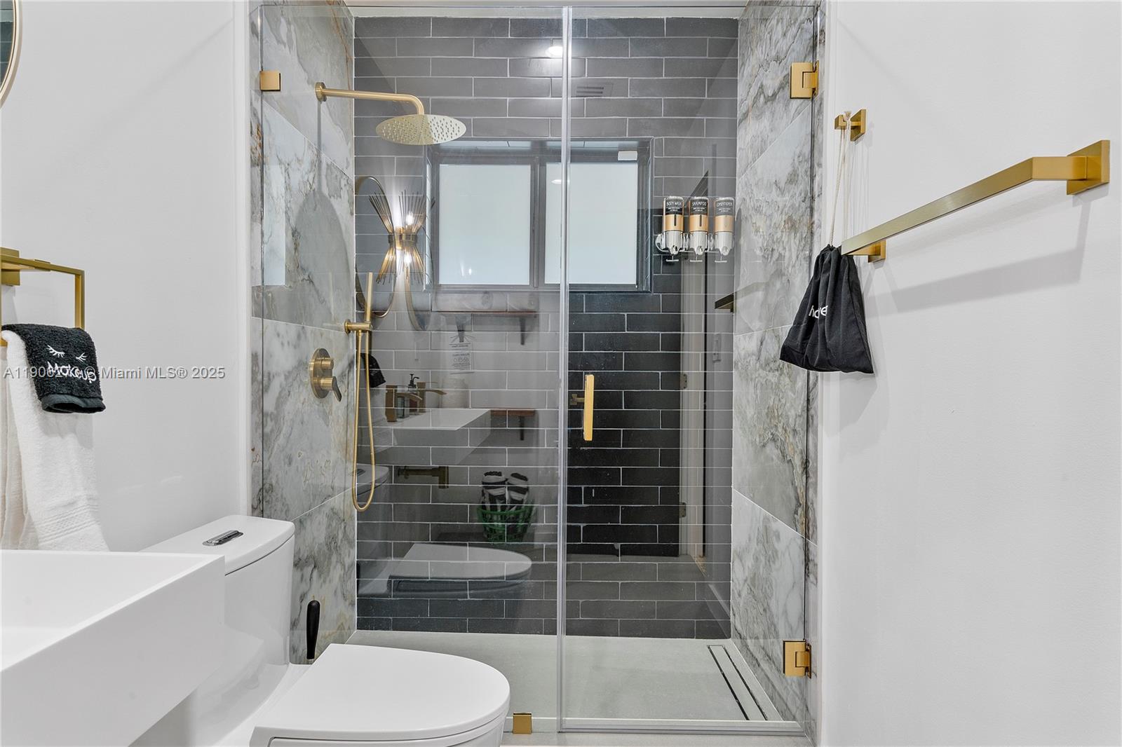 256 Northwest 57th Street Miami, FL 33127 - Photo 8 of 45 a bathroom with a shower toilet and sink