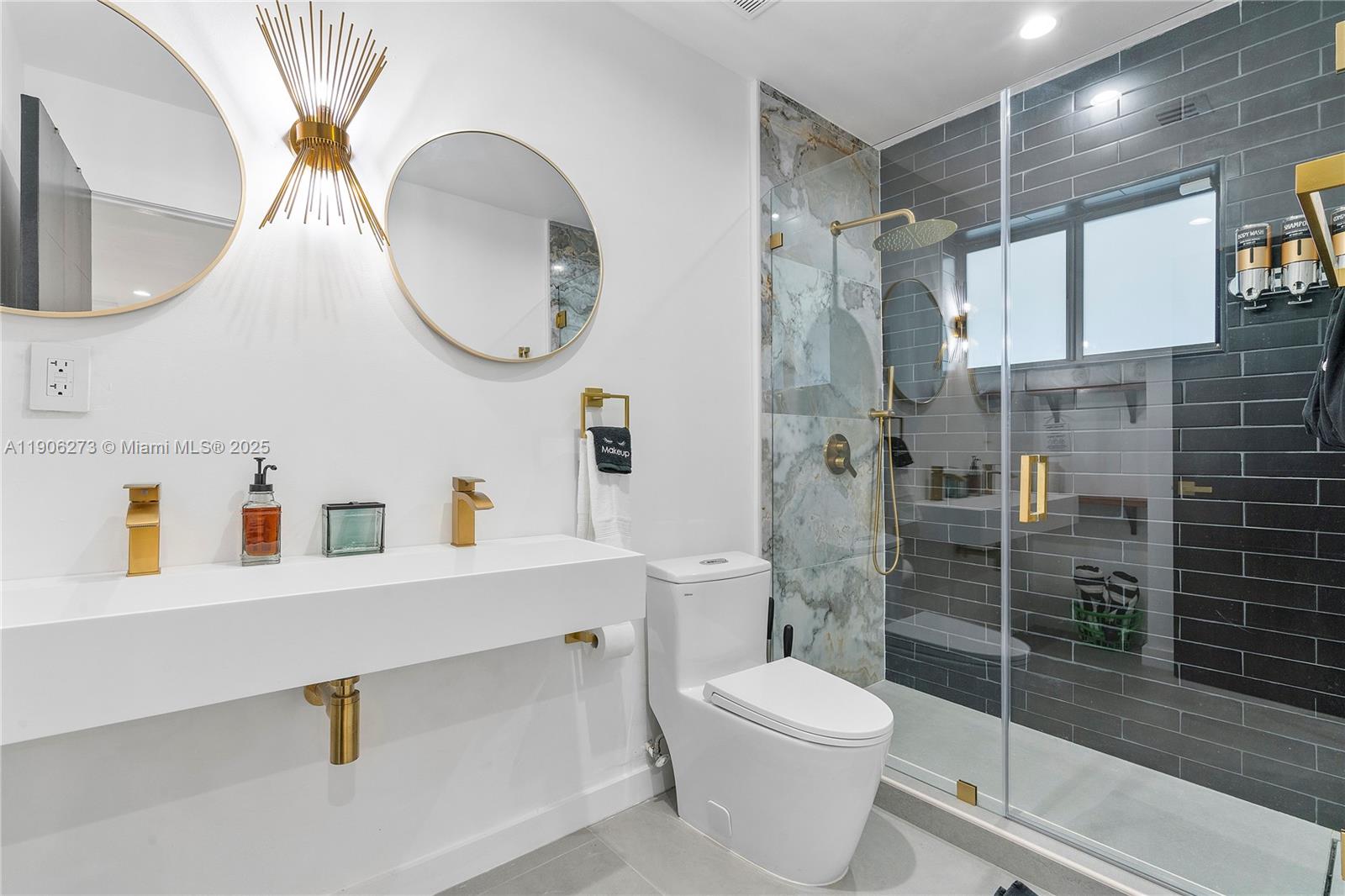 256 Northwest 57th Street Miami, FL 33127 - Photo 9 of 45 a bathroom with a sink a toilet and a mirror