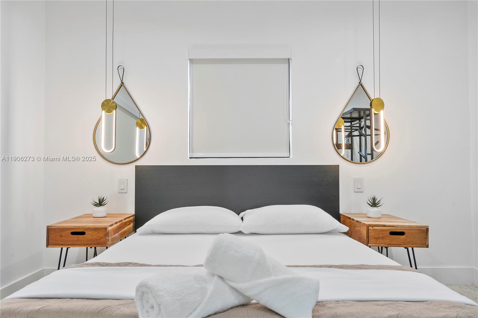 256 Northwest 57th Street Miami, FL 33127 - Photo 10 of 45 a bedroom with a bed a lamp and wooden floor