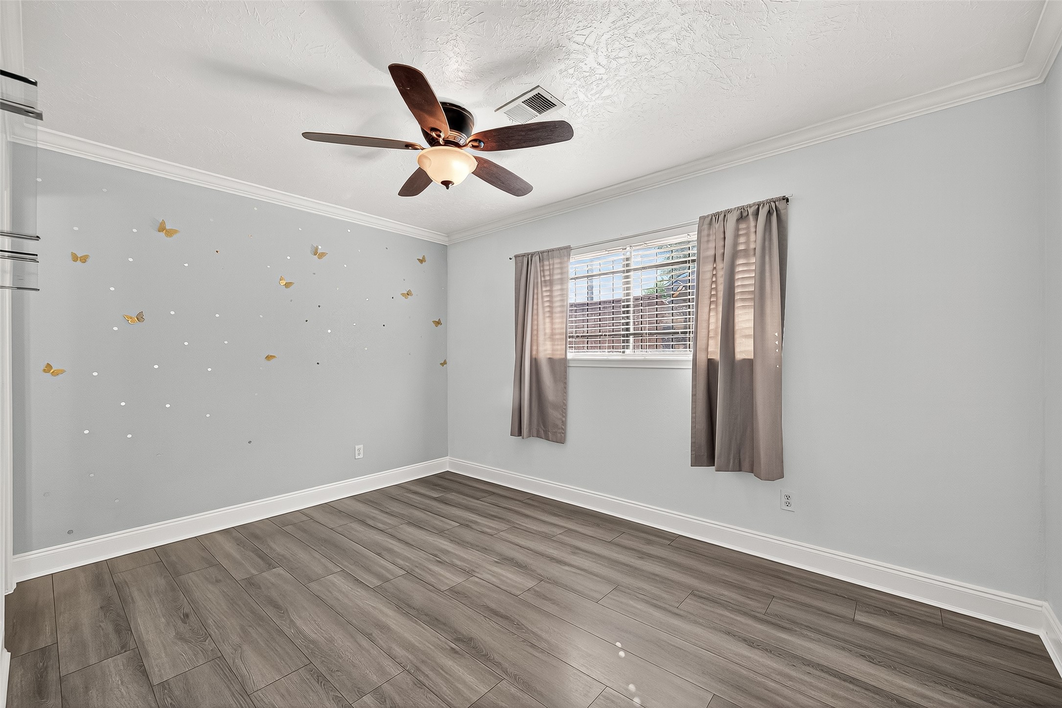 14007 Buffalo Speedway Houston, TX 77045 - Photo 26 of 46 a view of an empty room with wooden floor and a window