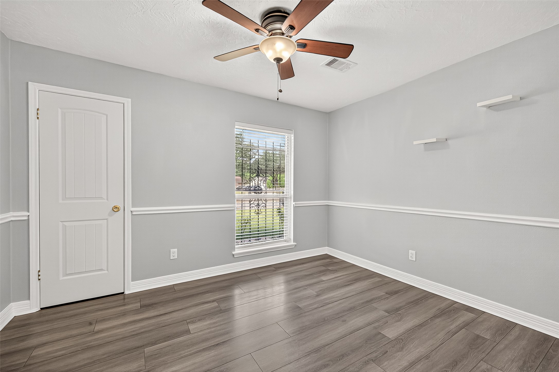 14007 Buffalo Speedway Houston, TX 77045 - Photo 30 of 46 wooden floor in an empty room with a window