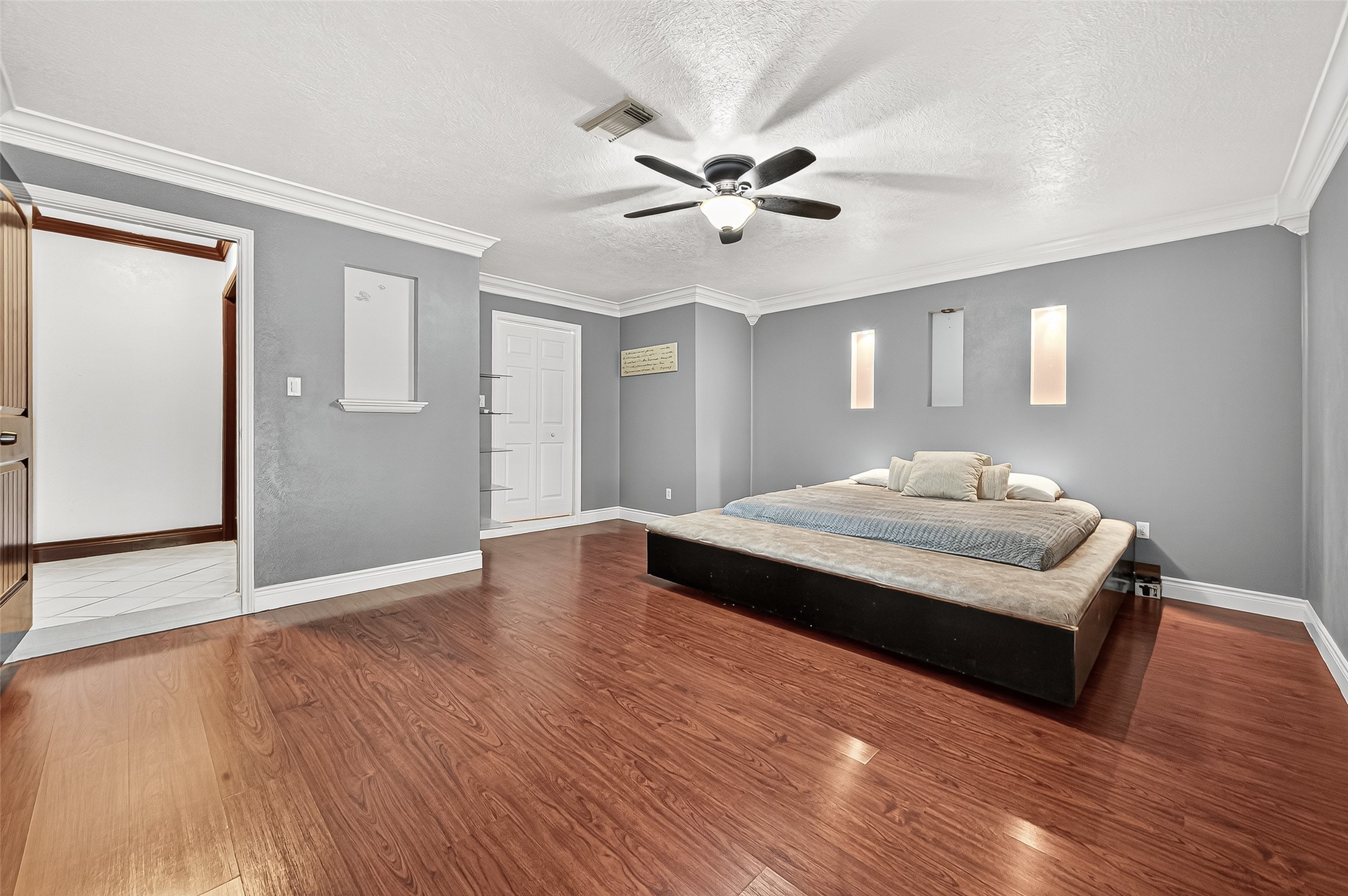 14007 Buffalo Speedway Houston, TX 77045 - Photo 35 of 46 a bedroom with a bed and wooden floor