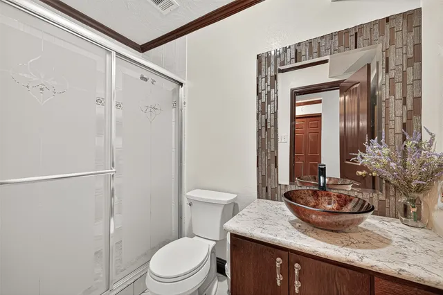 a view of a backyard with brick wall and fence