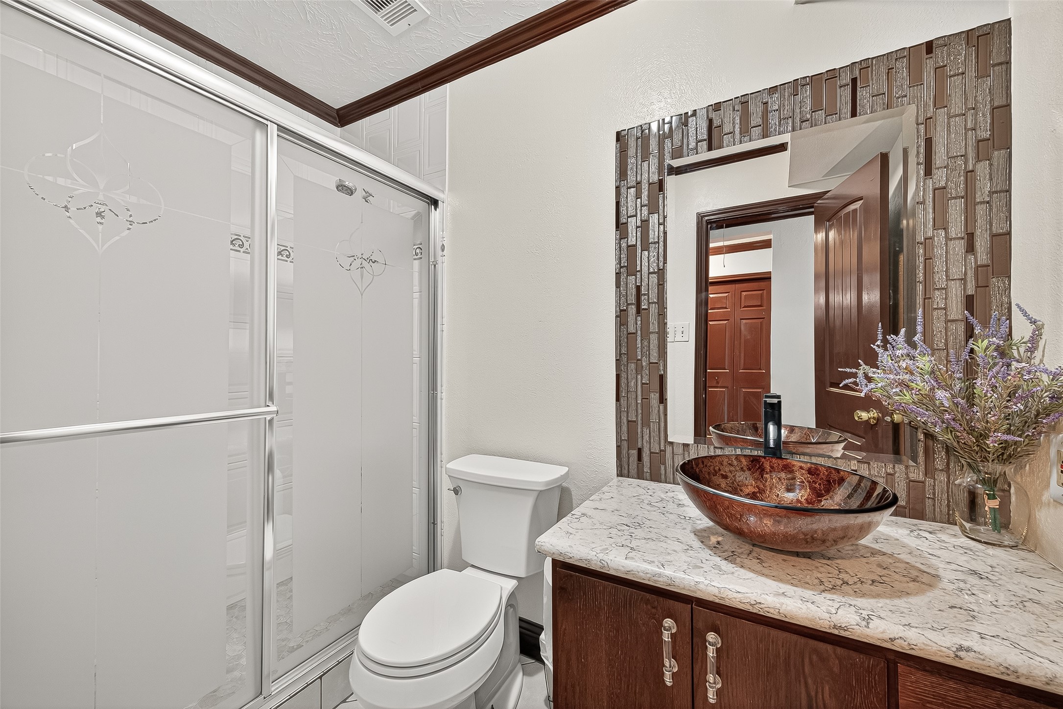 14007 Buffalo Speedway Houston, TX 77045 - Photo 36 of 46 a bathroom with a granite countertop sink toilet a mirror and shower