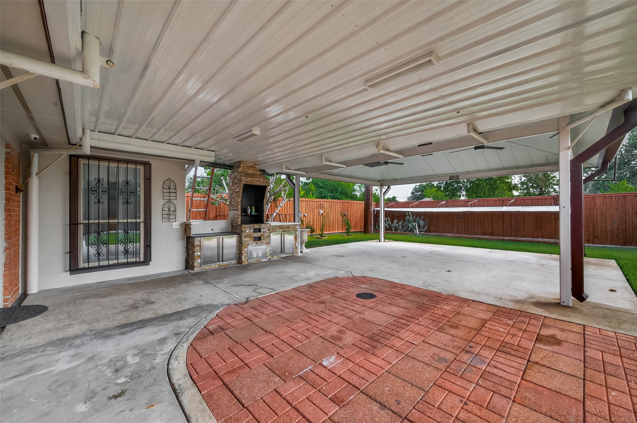 14007 Buffalo Speedway Houston, TX 77045 - Photo 39 of 46 a backyard of a house with barbeque oven table and chairs