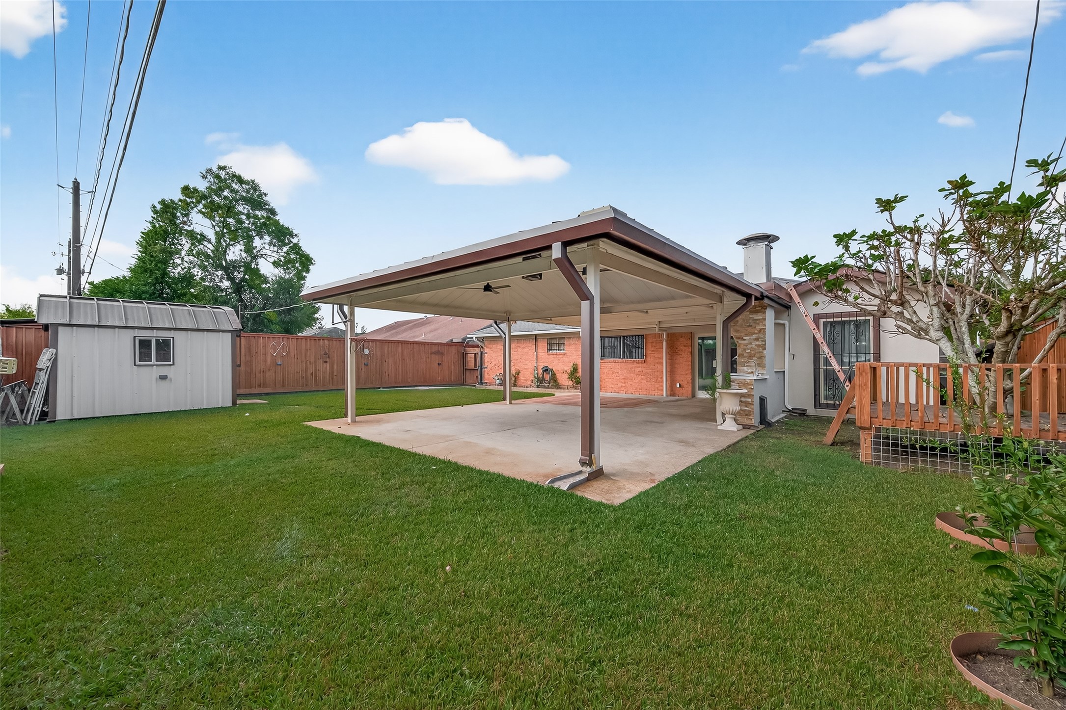14007 Buffalo Speedway Houston, TX 77045 - Photo 42 of 46 a front view of a house with a yard garage and outdoor seating