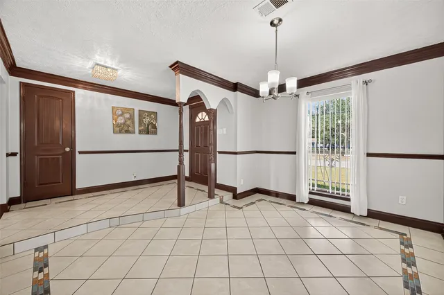 a view of a livingroom with furniture and a hallway