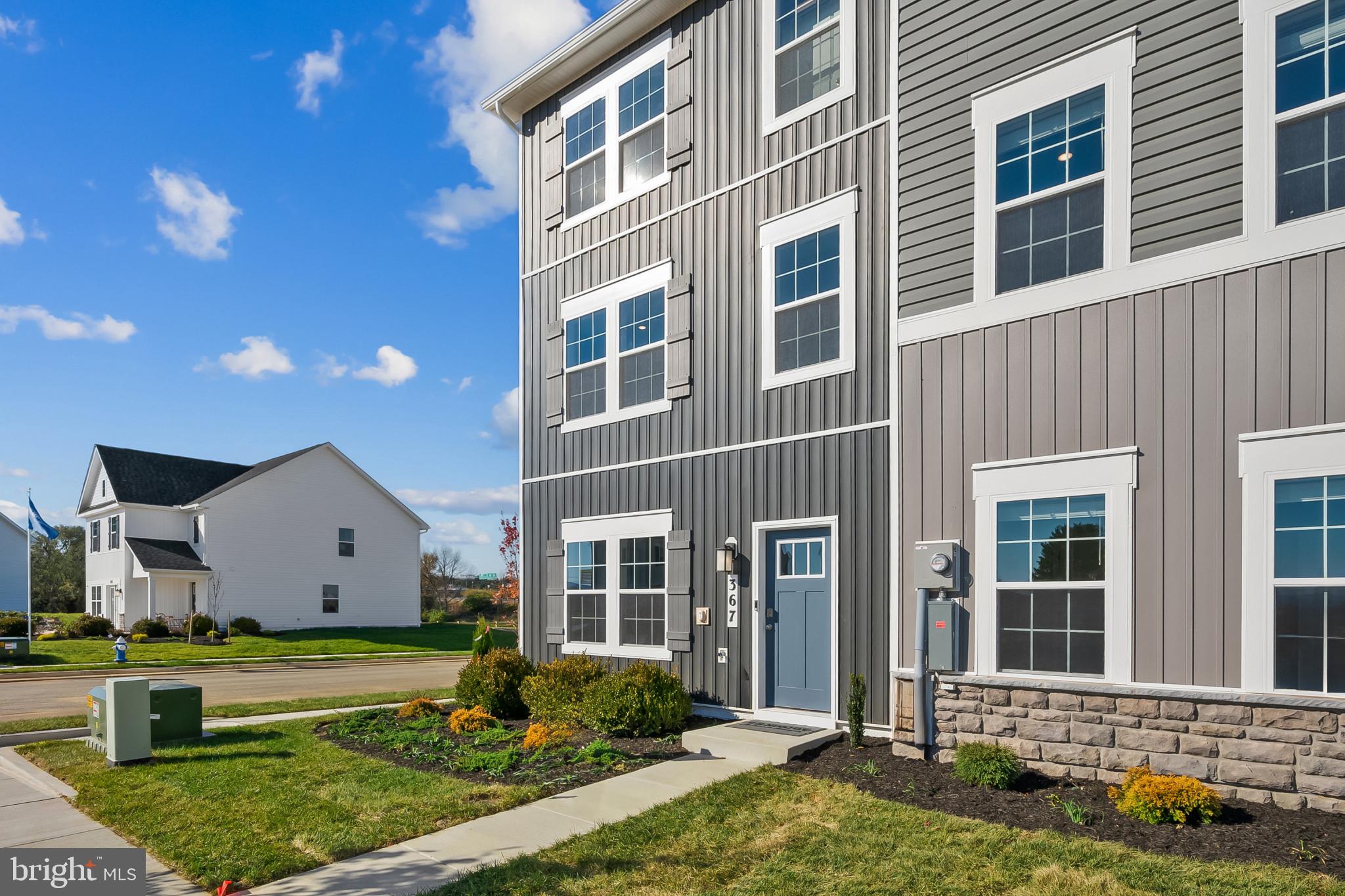 48 Aloma Street Ranson, WV 25438 - Photo 2 of 46 a front view of a house with a yard and garage