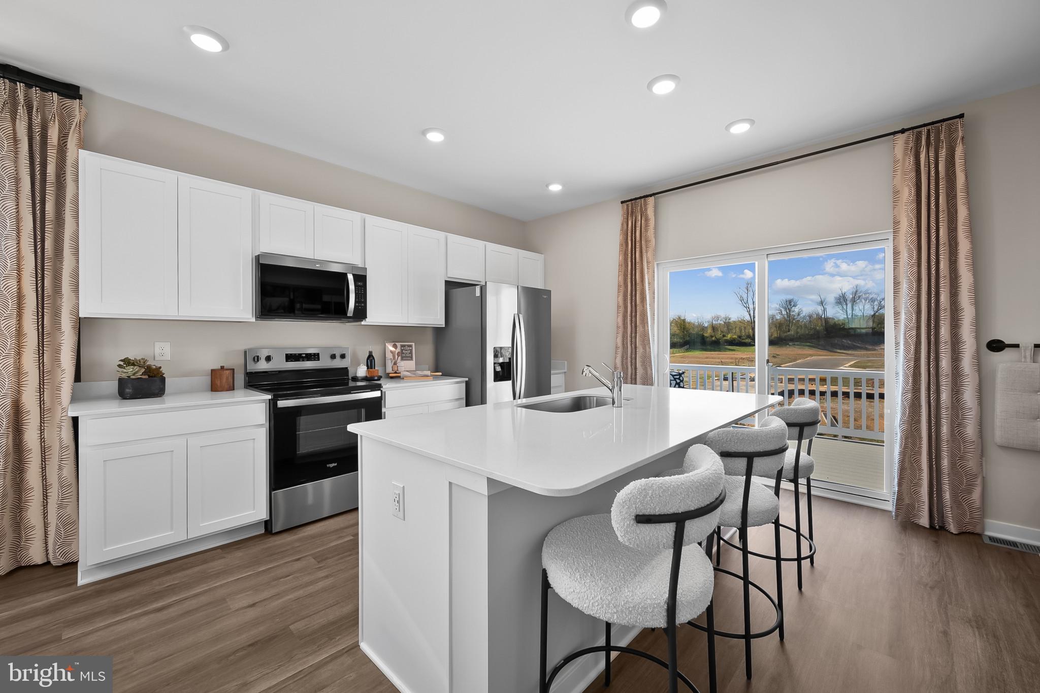 48 Aloma Street Ranson, WV 25438 - Photo 8 of 46 a kitchen with a dining table chairs and refrigerator