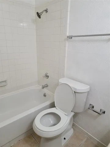 a bathroom with a toilet and a bathtub