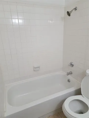 a view of a room with wooden floor and white walls