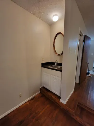 a view of a room with wooden floor