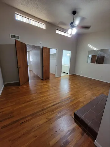a view of a room with wooden floor