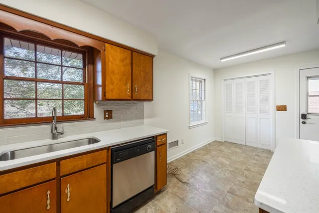 a kitchen with stainless steel appliances granite countertop a sink and a window