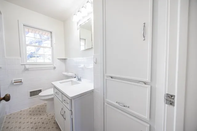 a bathroom with a sink toilet and vanity