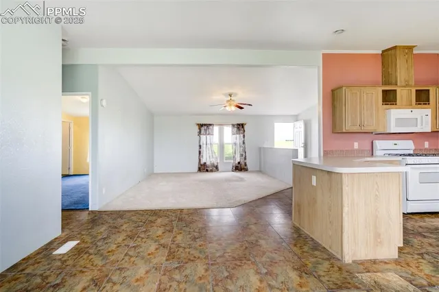 a kitchen with a sink a counter top space stainless steel appliances and cabinets
