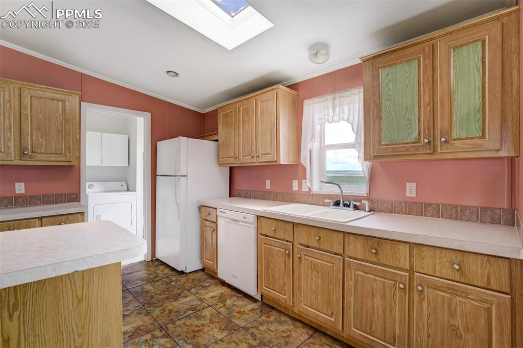 1435 Equestrian Point Yoder, CO 80864 - Photo 16 of 49 a kitchen with a sink stove and refrigerator