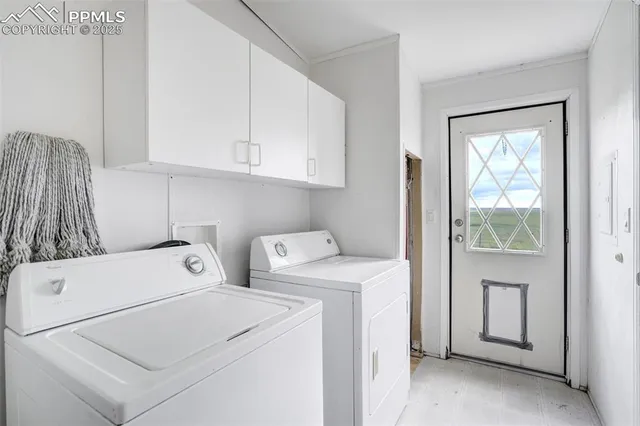 a view of an empty room with chandelier fan and windows