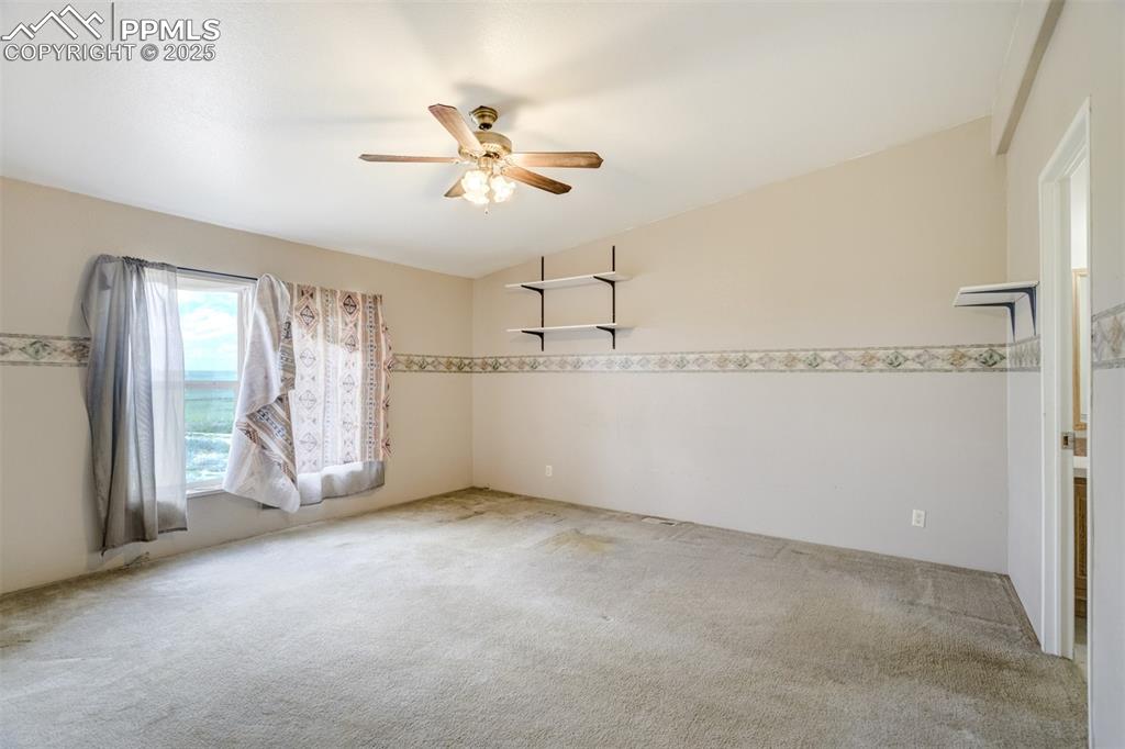 1435 Equestrian Point Yoder, CO 80864 - Photo 20 of 49 a view of an empty room with chandelier fan and windows
