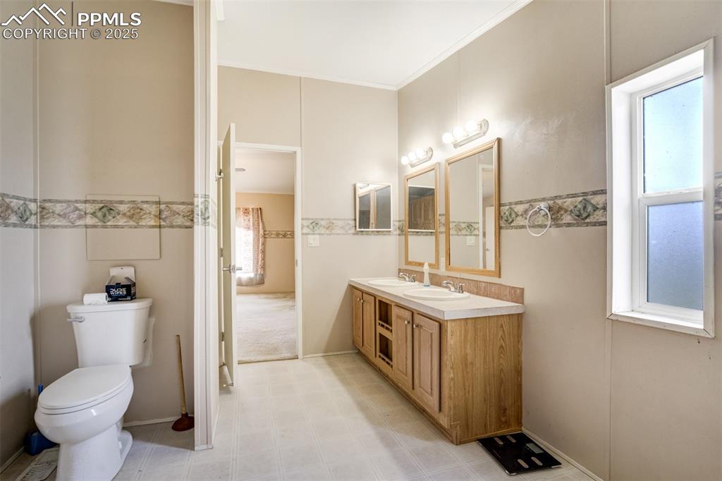1435 Equestrian Point Yoder, CO 80864 - Photo 24 of 49 a bathroom with a sink toilet and shower