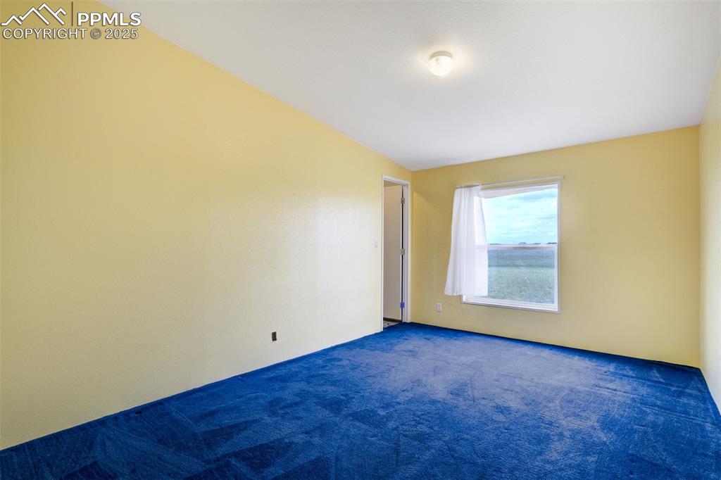 1435 Equestrian Point Yoder, CO 80864 - Photo 25 of 49 an empty room with wooden floor and windows