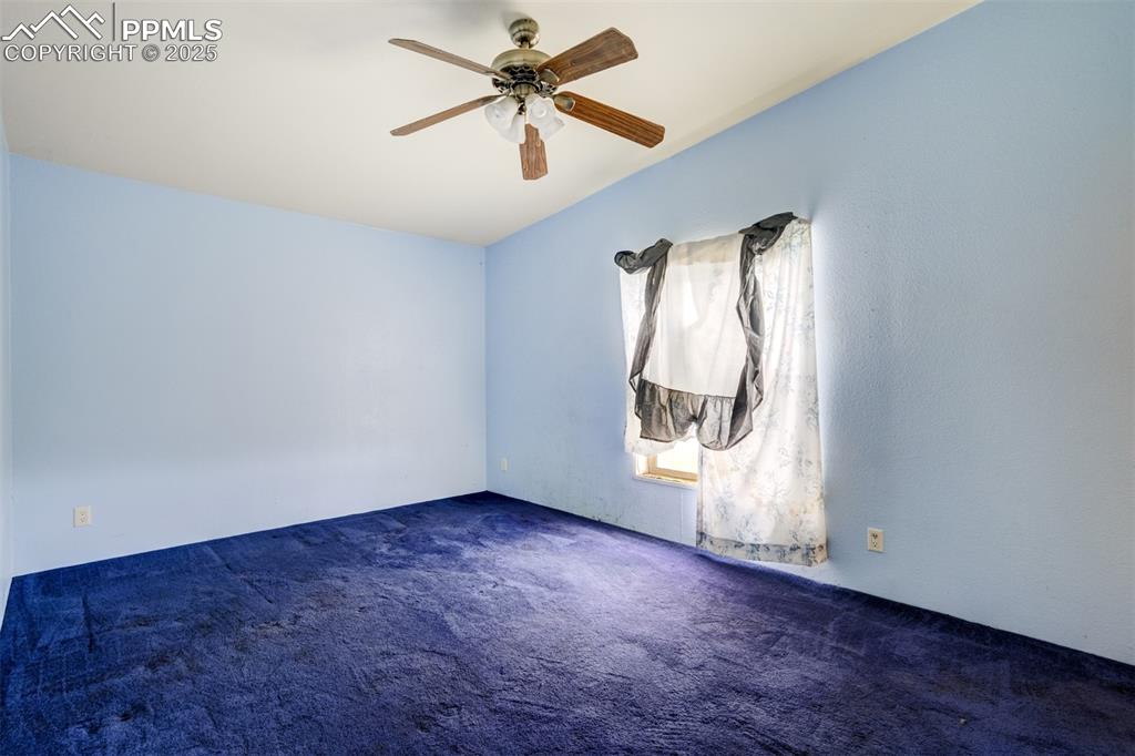 1435 Equestrian Point Yoder, CO 80864 - Photo 27 of 49 an empty room with a window and a fan