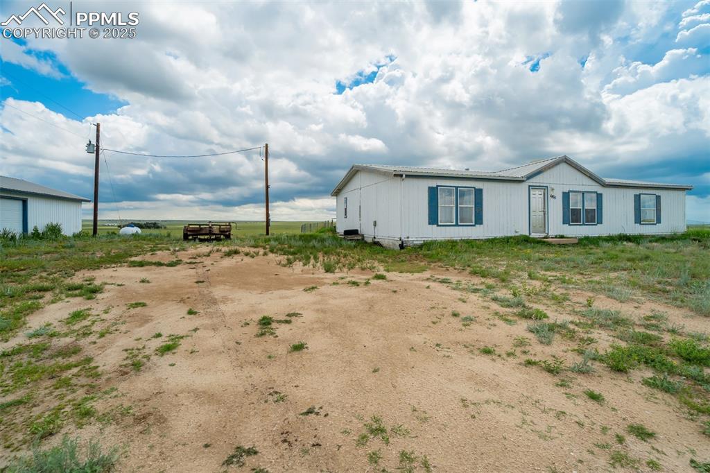 1435 Equestrian Point Yoder, CO 80864 - Photo 8 of 49 a view of a house with a backyard