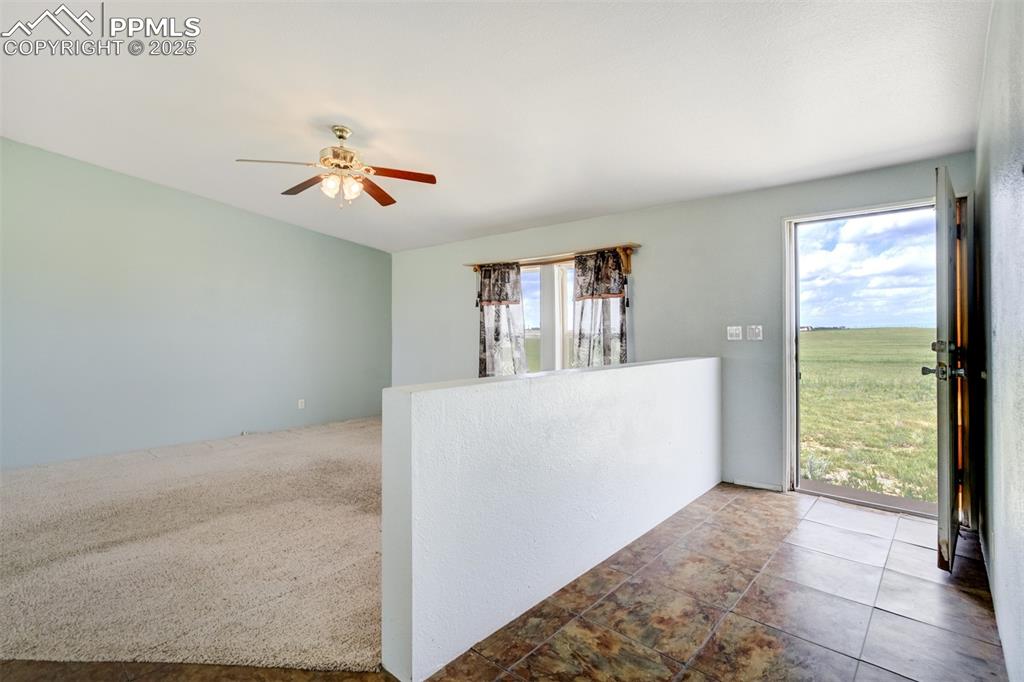 1435 Equestrian Point Yoder, CO 80864 - Photo 9 of 49 a view of room with window and a ceiling fan