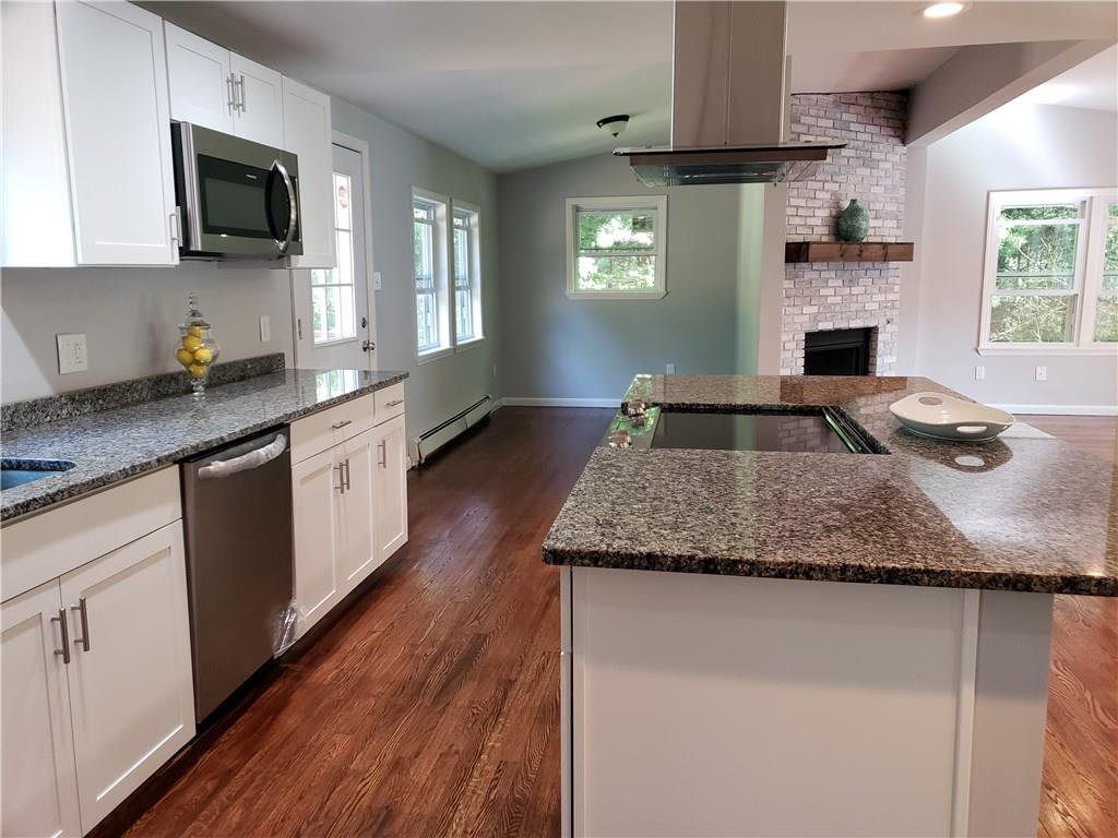 91 Boehmler Road Sparrowbush, NY 12780 - Photo 1 of 1 a kitchen with granite countertop stainless steel appliances a stove sink microwave and cabinets