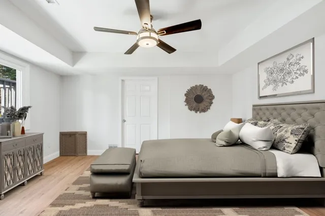 a view of a white house with a big yard and large trees