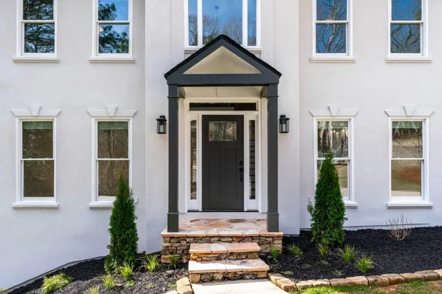a view of empty room with wooden floor and fireplace