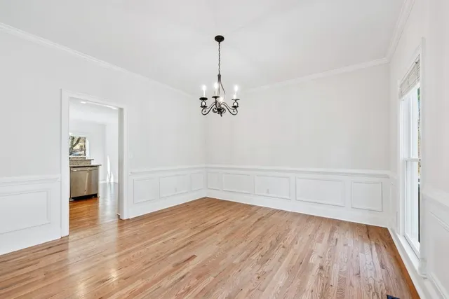 a kitchen with granite countertop white cabinets and stainless steel appliances