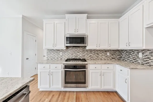 a bathroom with a sink toilet vanity and shower
