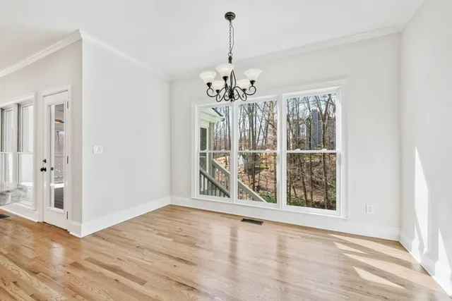 a view of an empty room with a ceiling fan