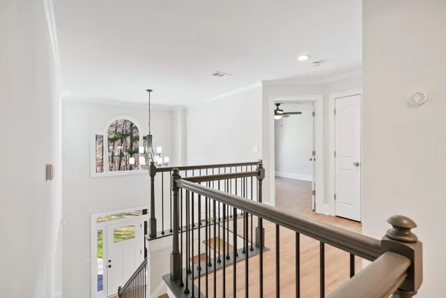 a view of a room with wooden floor and ceiling fan