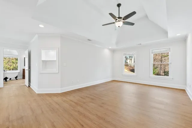 a view of a room with wooden floor and white walls