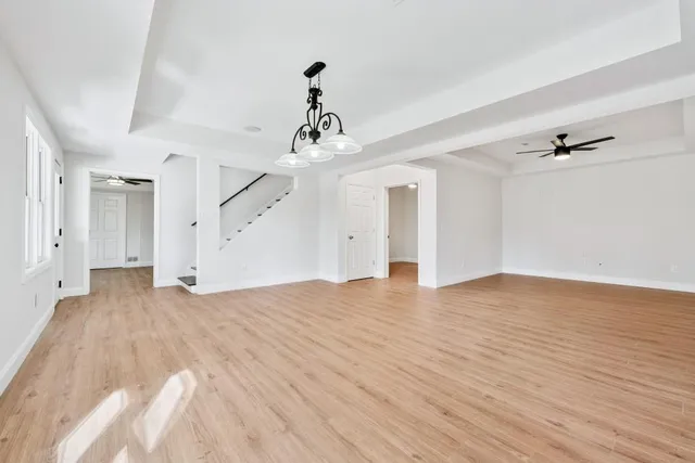a front view of a house with a yard and mountain view in back