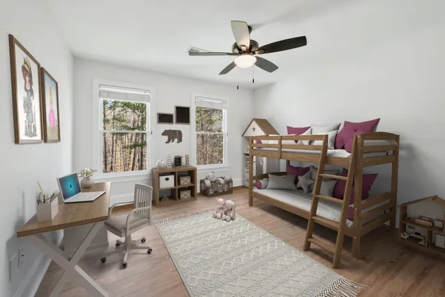 a living room with pool table and a wooden floor