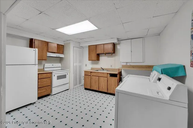 a kitchen with a refrigerator and a stove