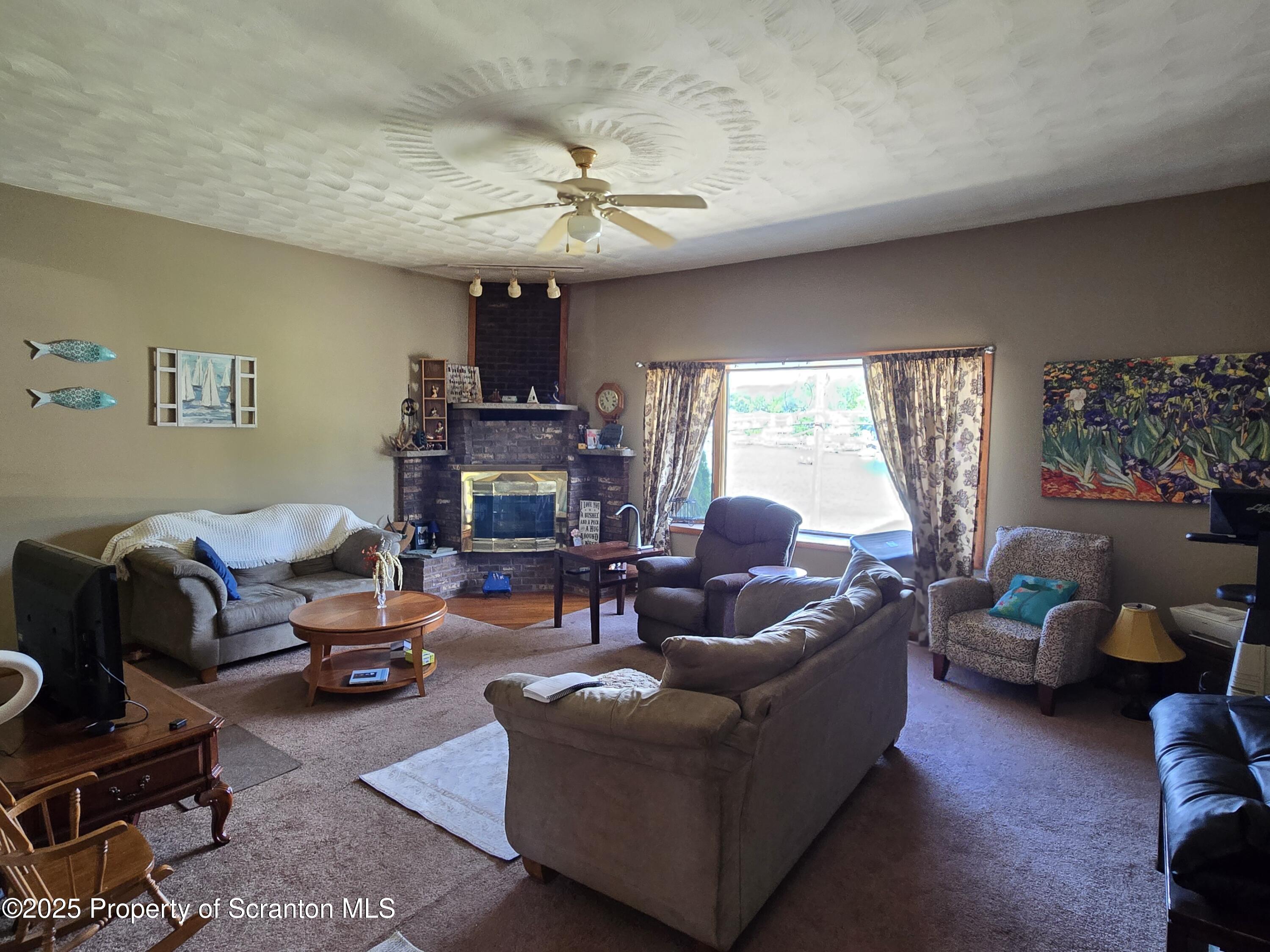 1228 Lake Road Factoryville, PA 18419 - Photo 13 of 31 a living room with furniture and a large window