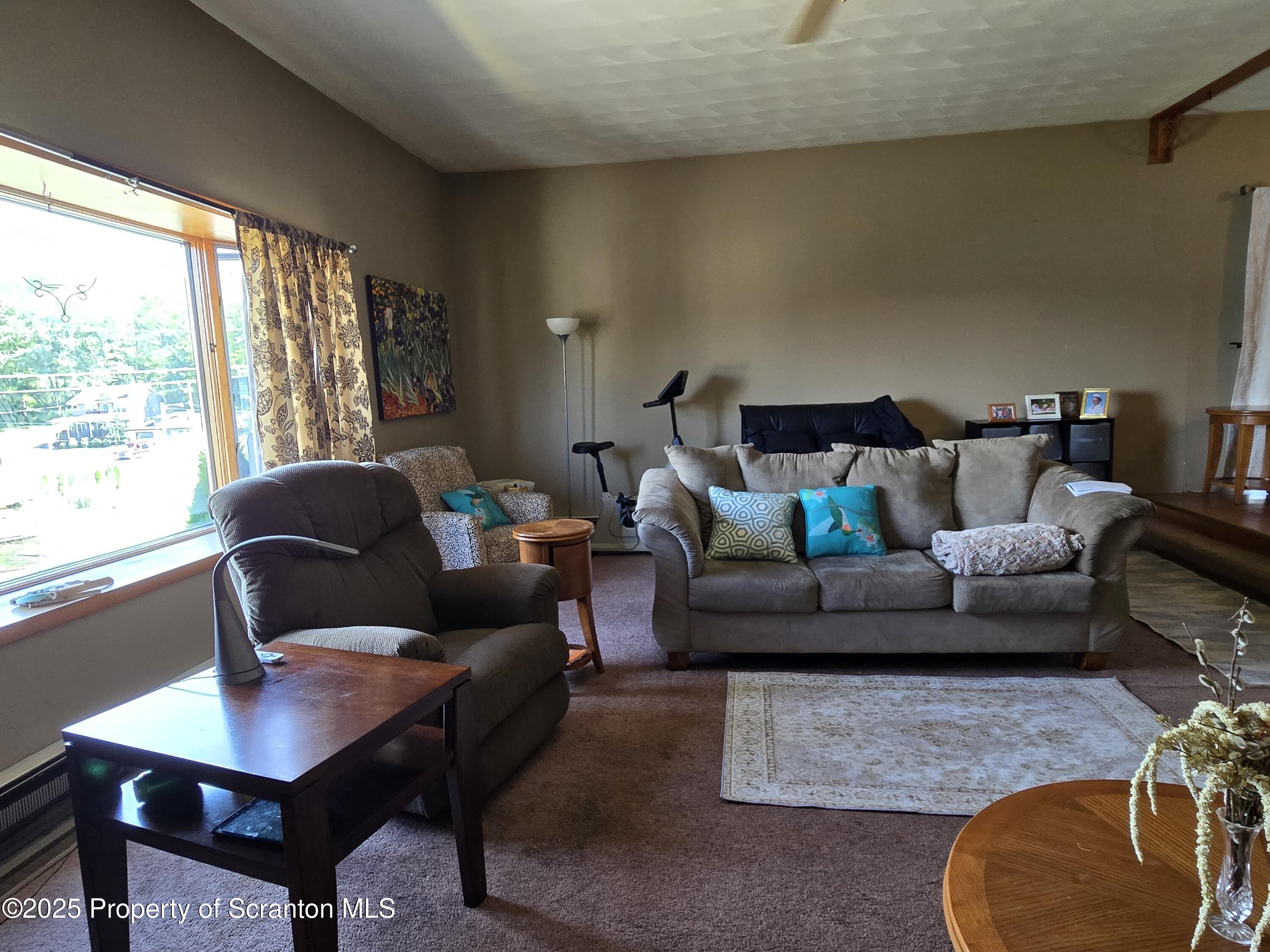 1228 Lake Road Factoryville, PA 18419 - Photo 14 of 31 a living room with furniture and a large window