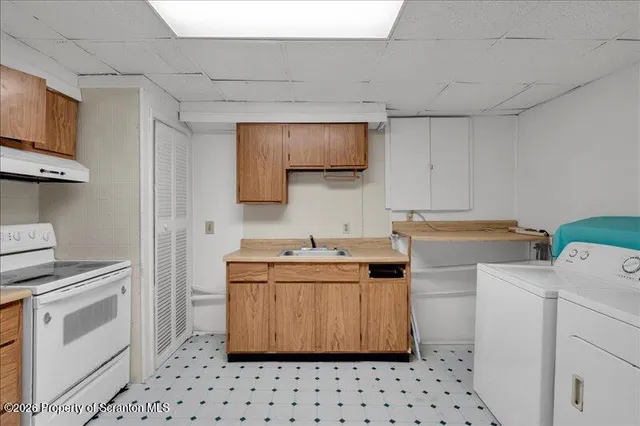 a bathroom with a toilet sink vanity and mirror
