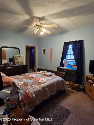 a bedroom with bed and window