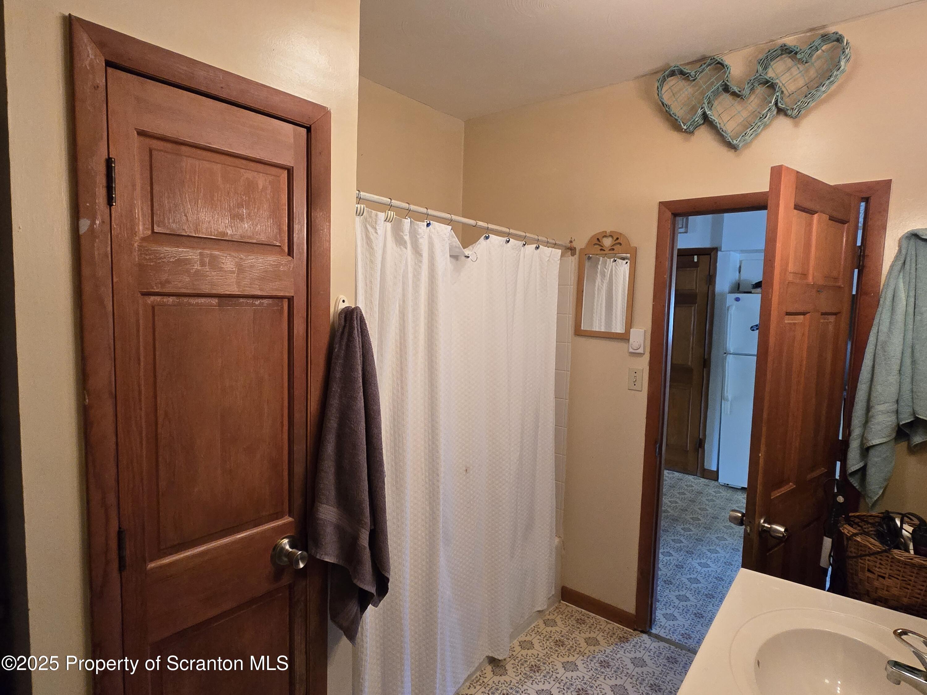 1228 Lake Road Factoryville, PA 18419 - Photo 20 of 31 a bathroom with a shower toilet and sink