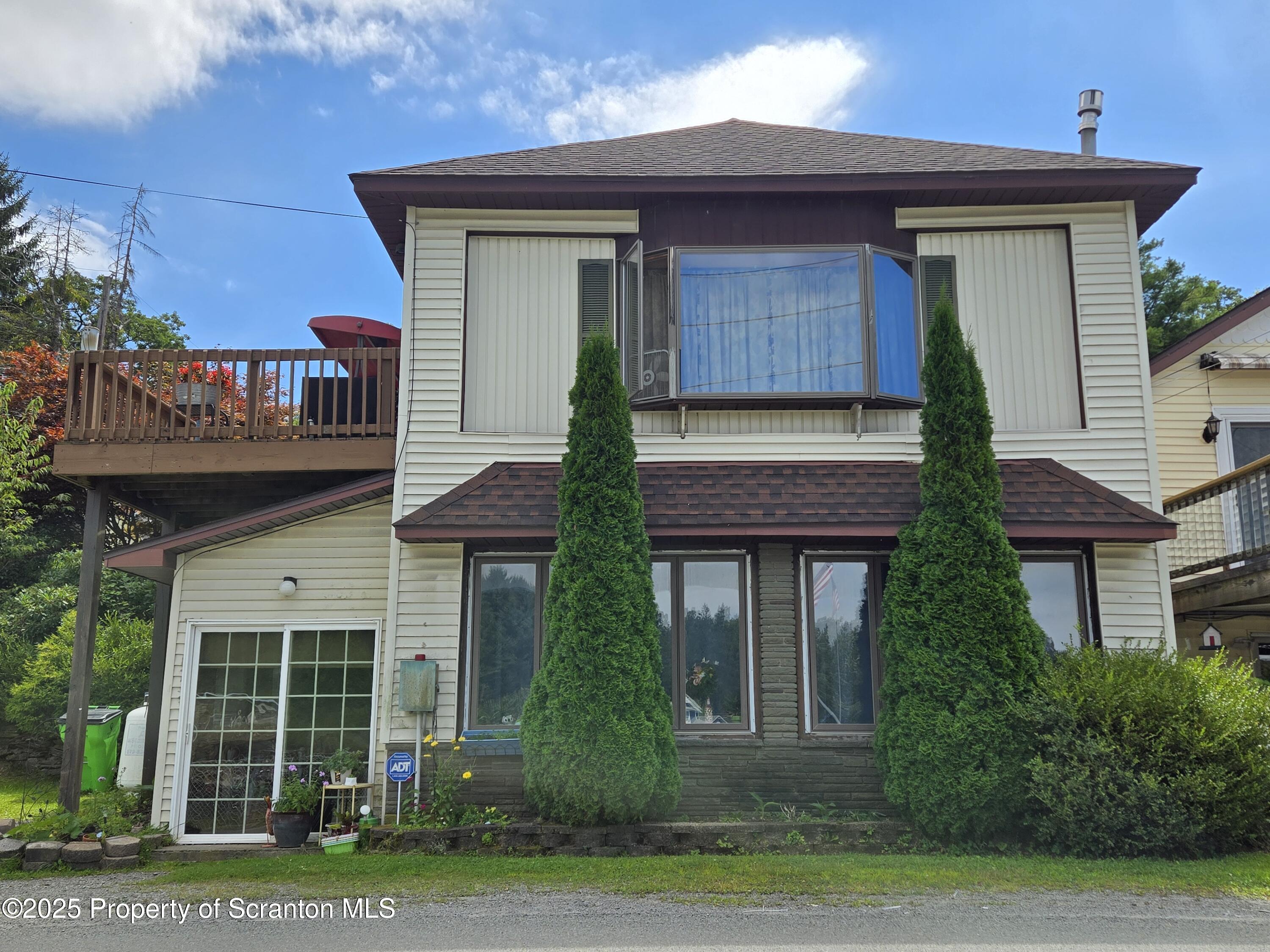 1228 Lake Road Factoryville, PA 18419 - Photo 2 of 31 a front view of a house with a yard and potted plants