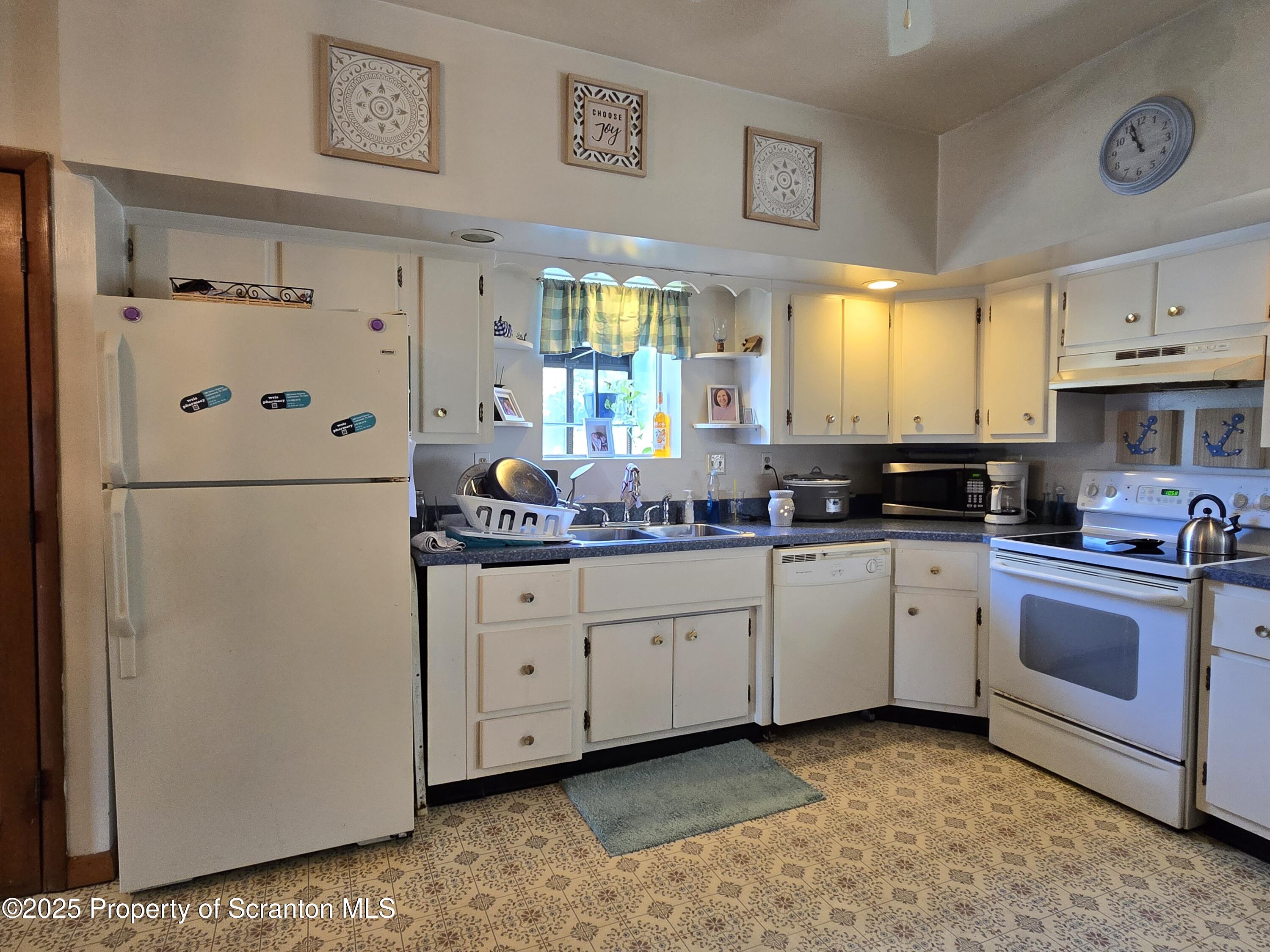 1228 Lake Road Factoryville, PA 18419 - Photo 21 of 31 a kitchen with stainless steel appliances granite countertop a refrigerator sink and cabinets