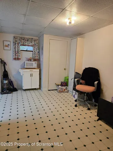 a living room with a couch and a stove next to a window