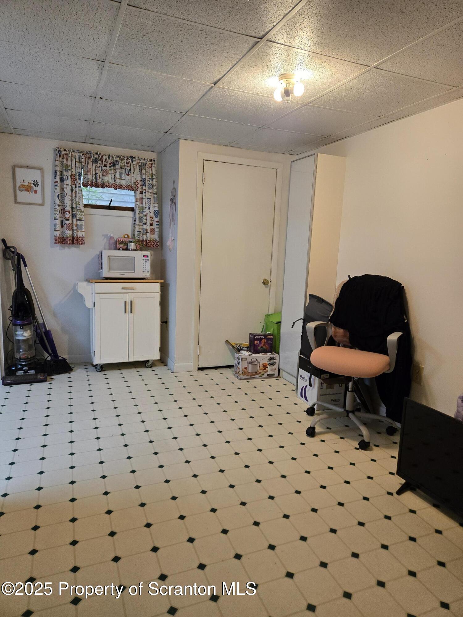 1228 Lake Road Factoryville, PA 18419 - Photo 26 of 31 a living room with a couch and a stove next to a window